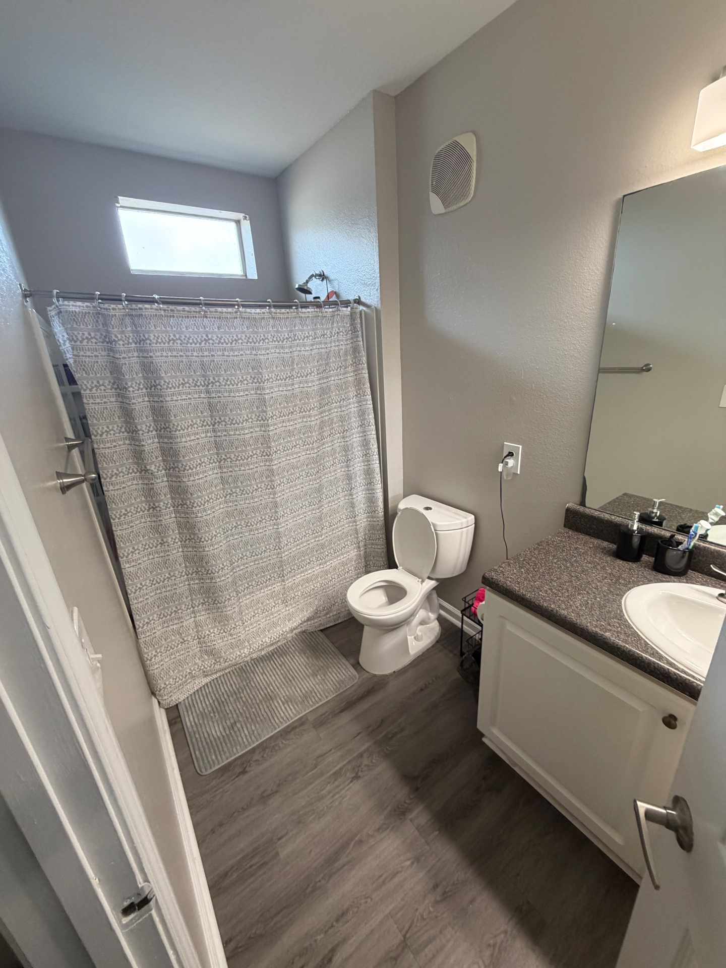 Freshly cleaned guest bathroom with shower curtain