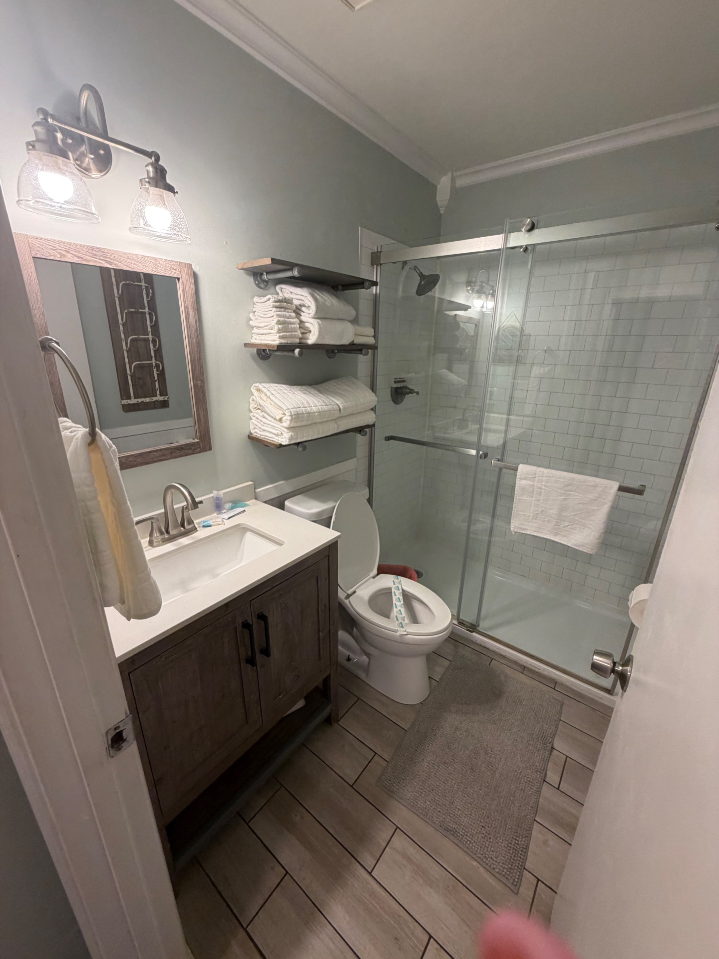 Spotless bathroom with glass shower and folded towels