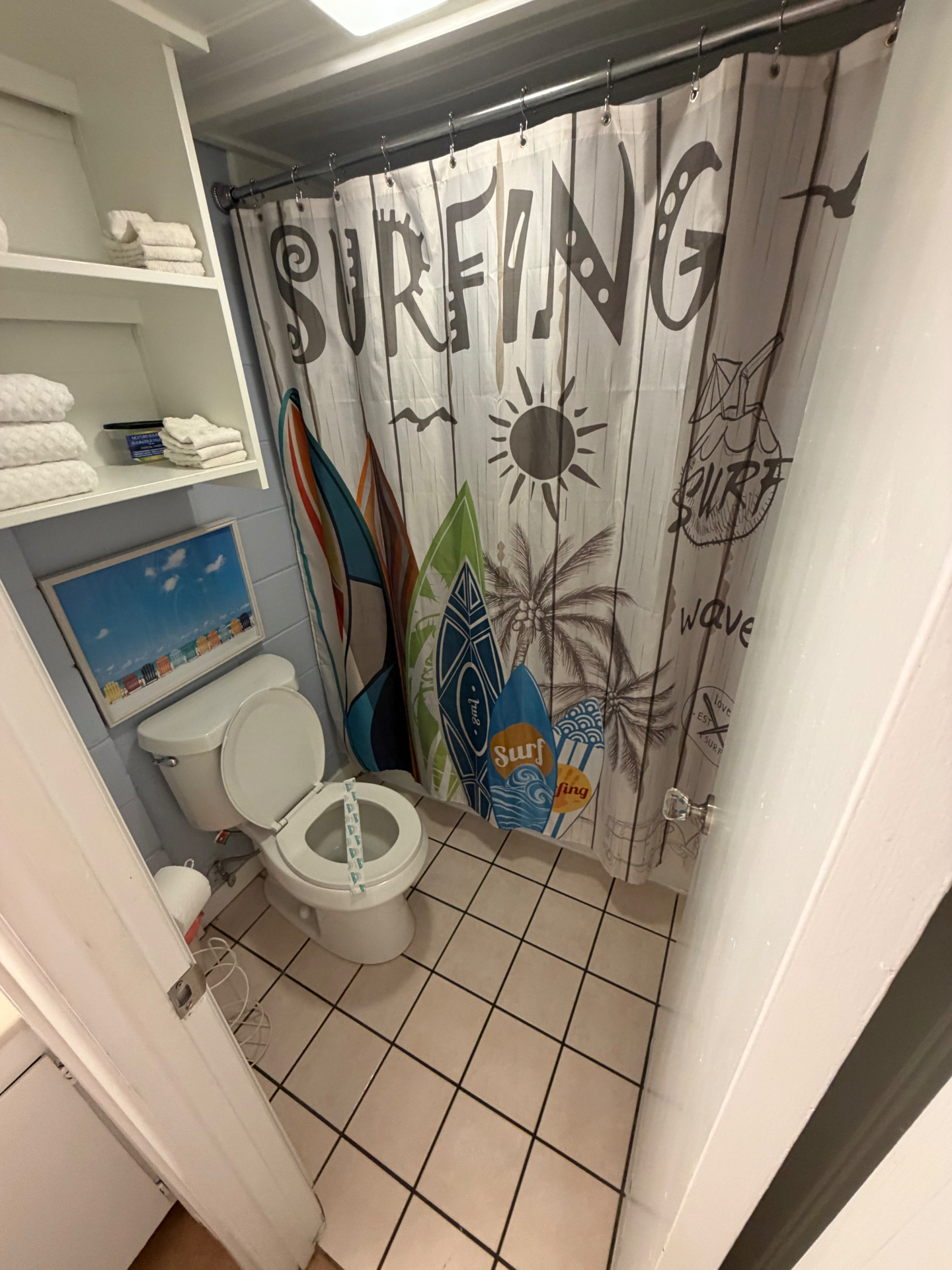 Beachy bathroom with surfing-themed shower curtain