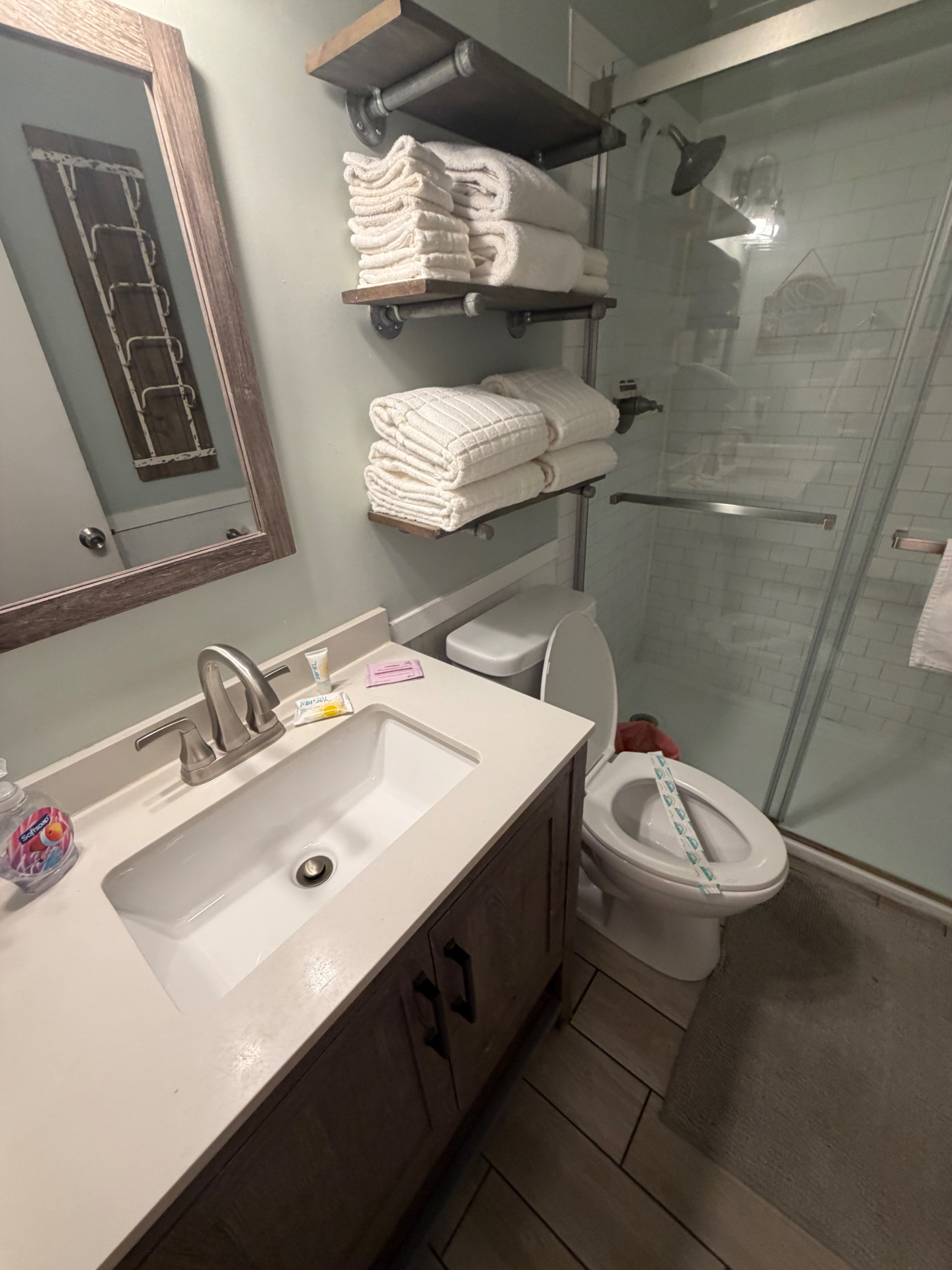 Clean rental bathroom with stacked fresh towels