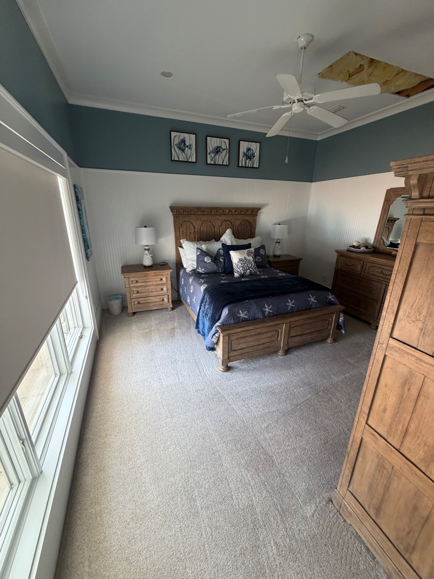 Spacious guest bedroom with navy coastal decor