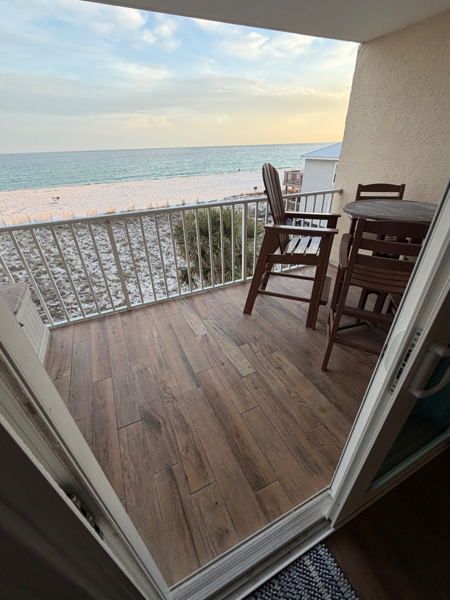 Beachfront balcony with ocean view at sunset