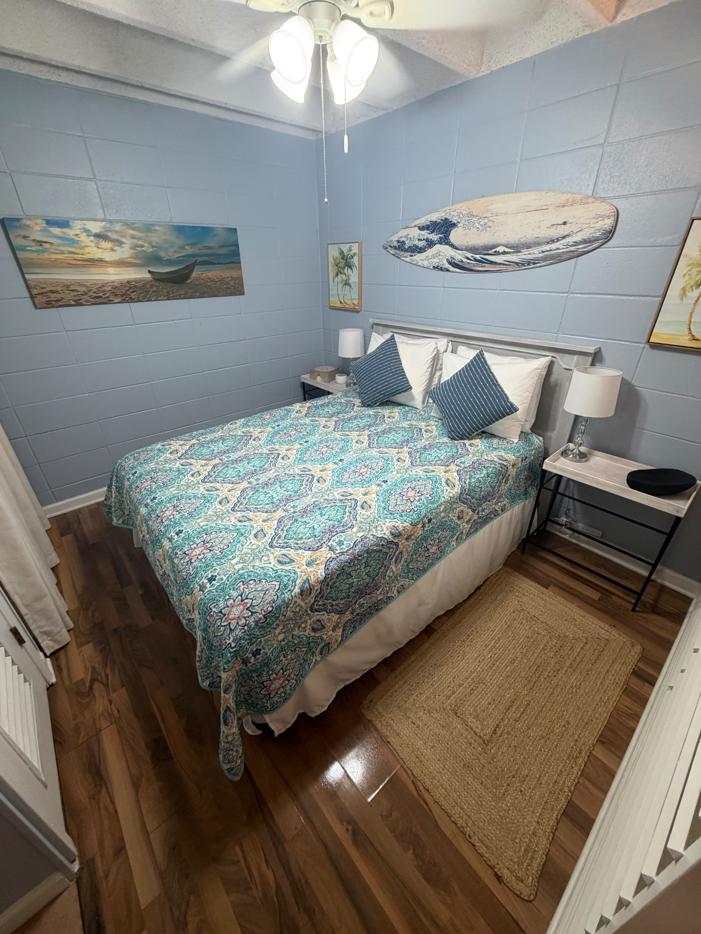 Coastal-themed bedroom with surfboard wall art and beach decor