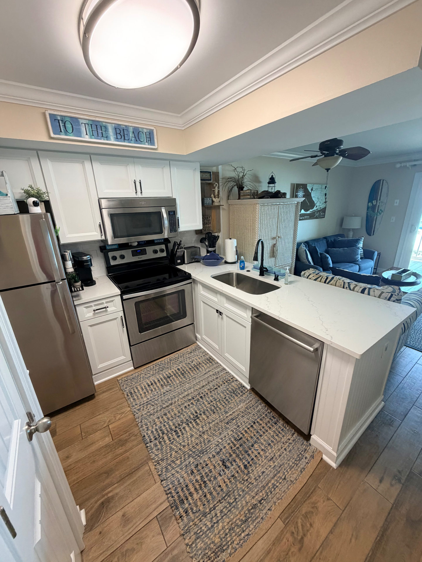 Bright coastal kitchen with teal backsplash
