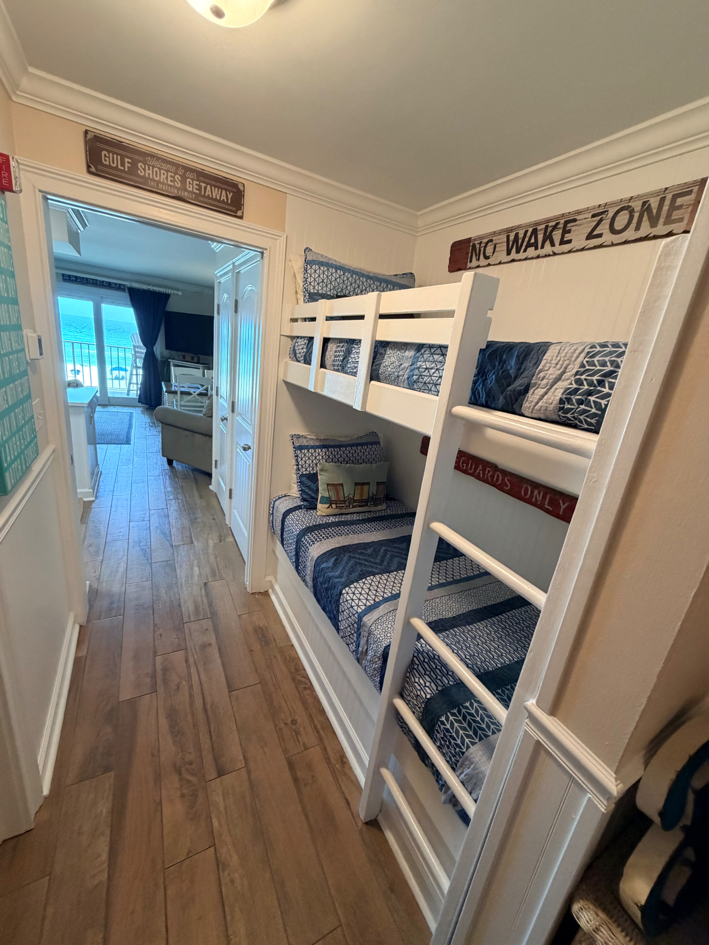 Coastal bunk room with beach signs in a Gulf Shores rental
