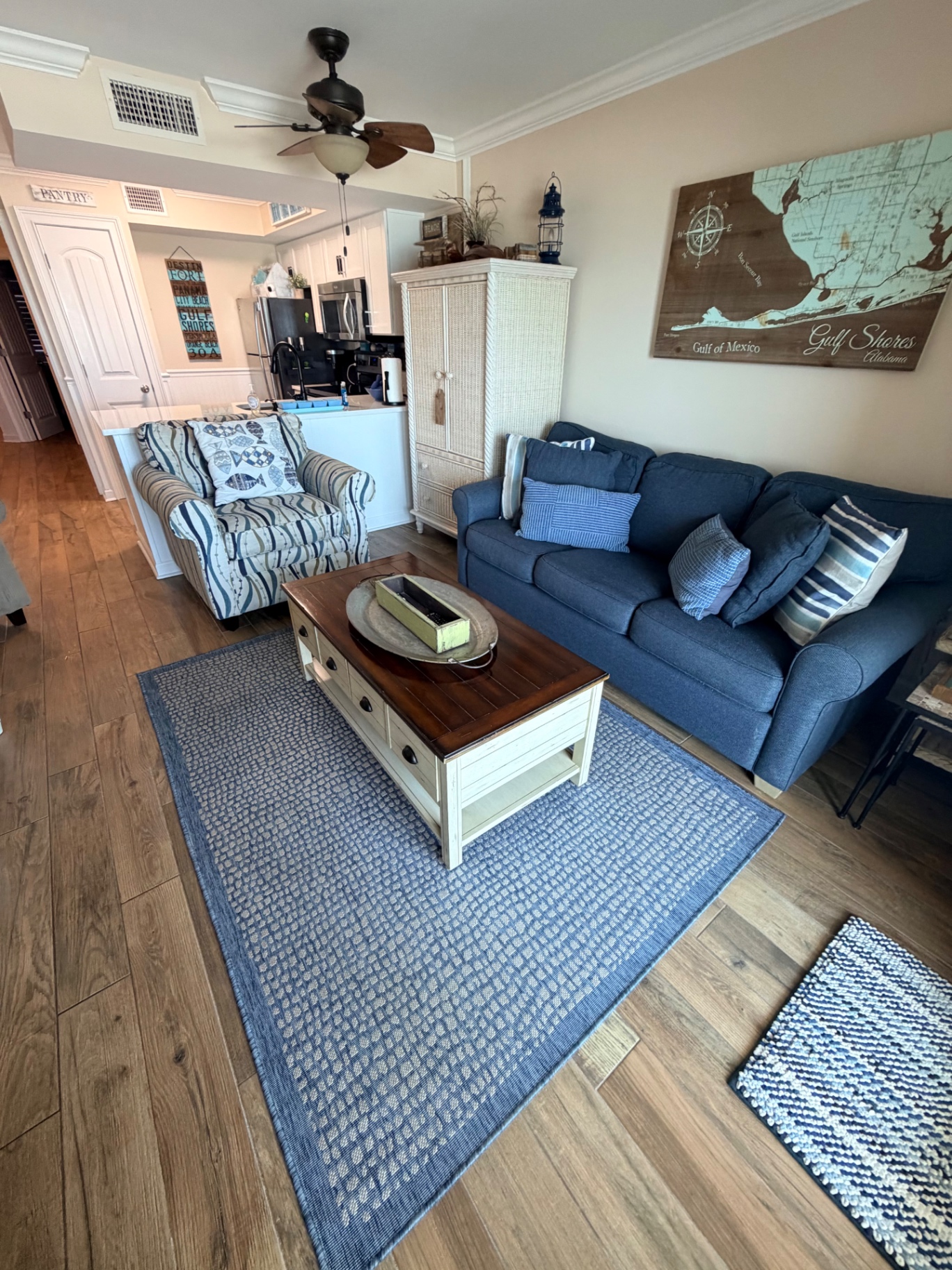 Beachy living room with Gulf Shores map art in a vacation rental